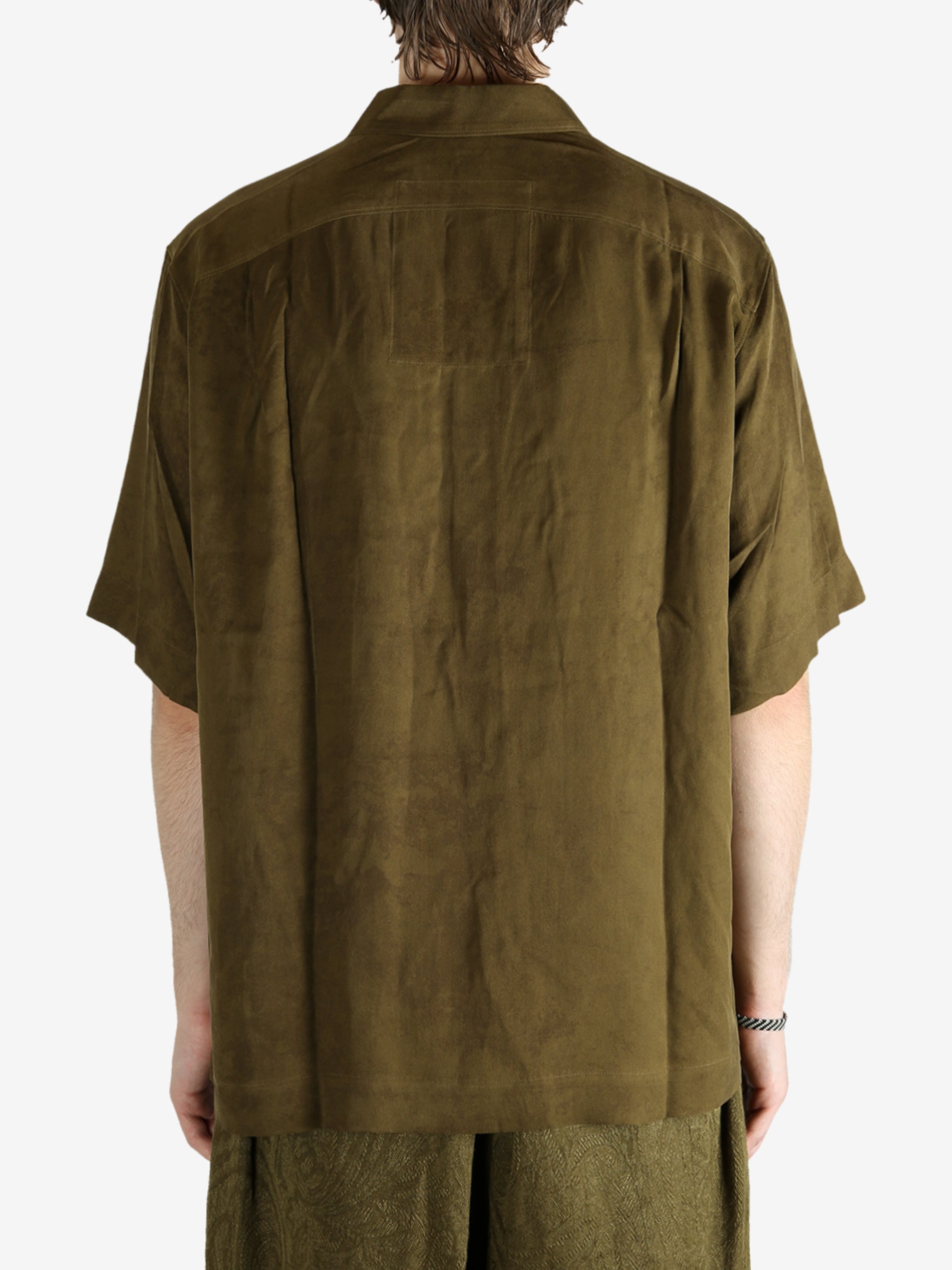 Green shirt worn by a person, showing the shirt's fit