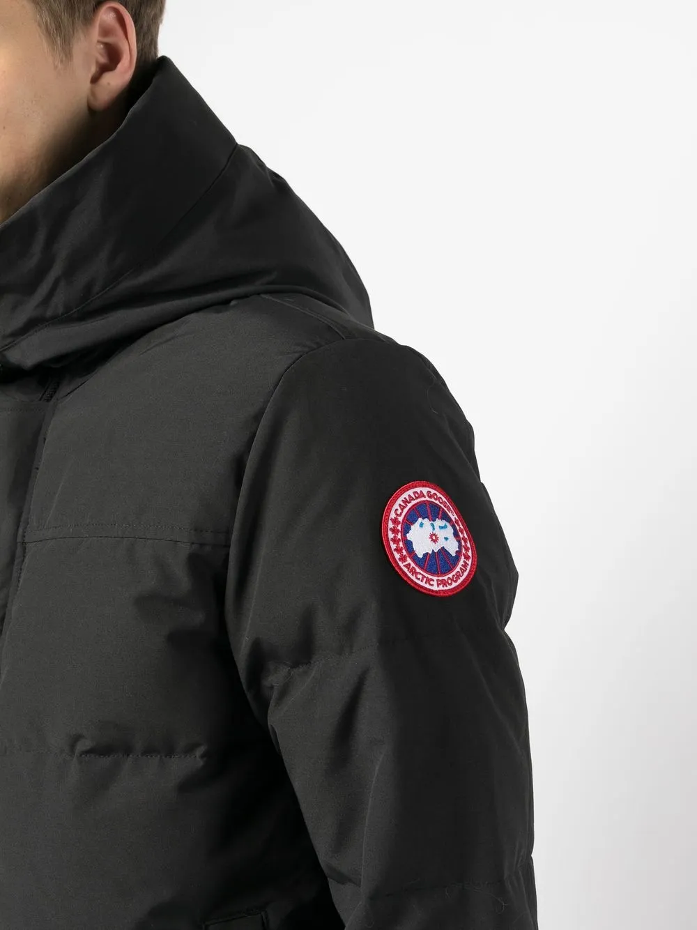 close up of black jackets-coats, showing texture of the polyester and cotton fabric