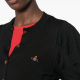 Black top worn by a person, showing the top fit