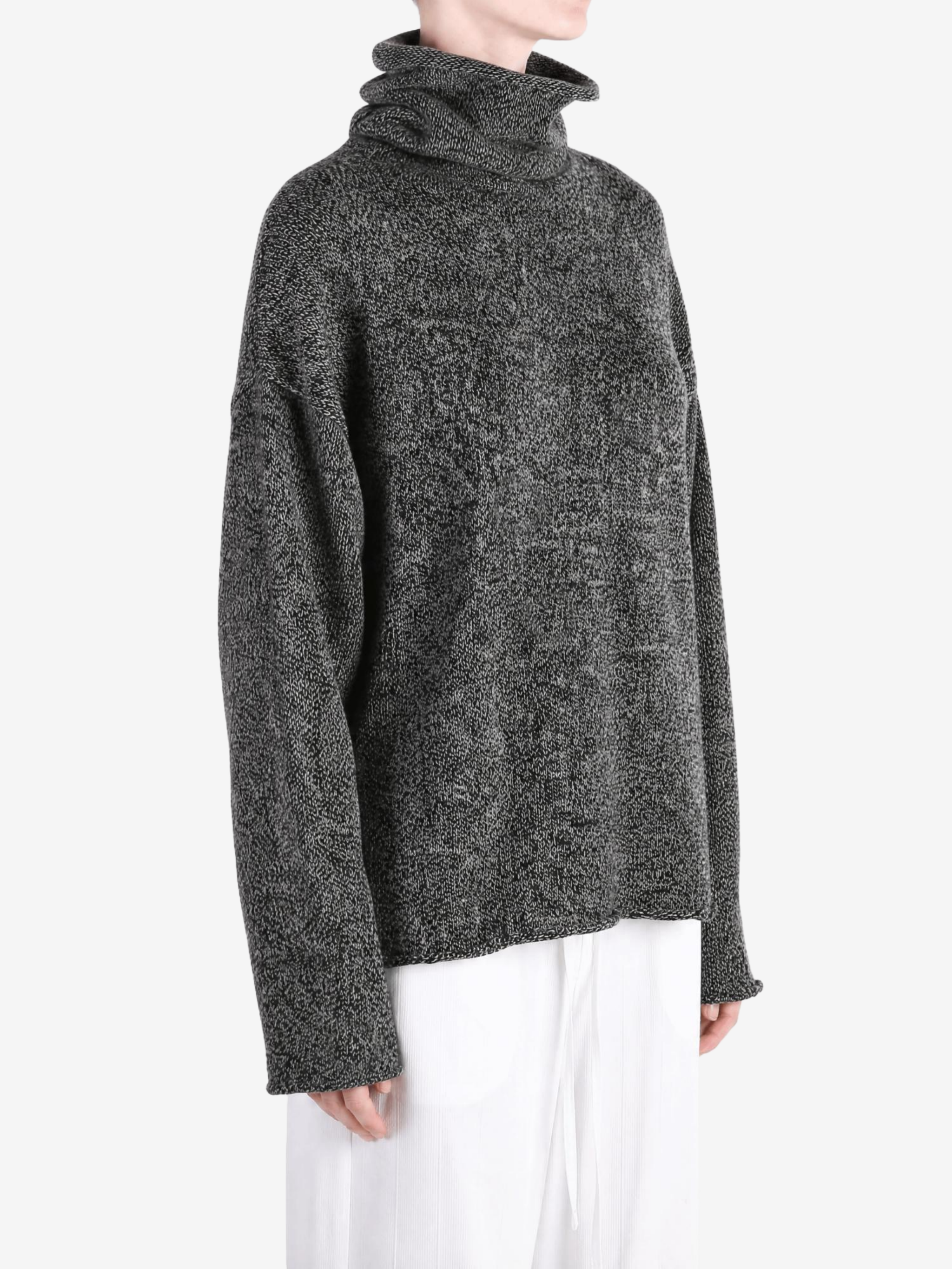 Grey knitwear worn by a person, showing the knitwear fit