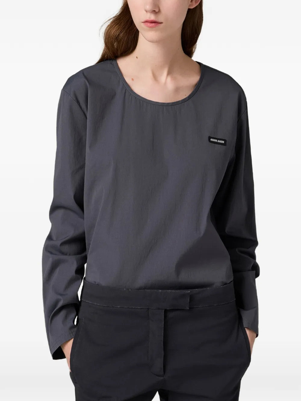 Grey top worn by a person, showing the top fit
