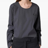 Grey top worn by a person, showing the top fit