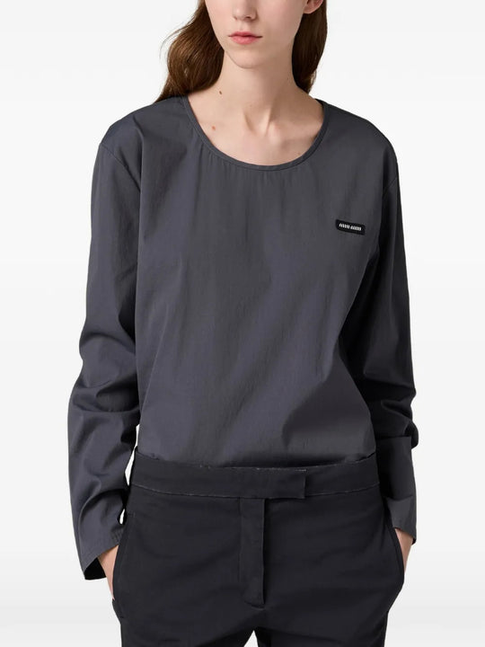 Grey top worn by a person, showing the top fit