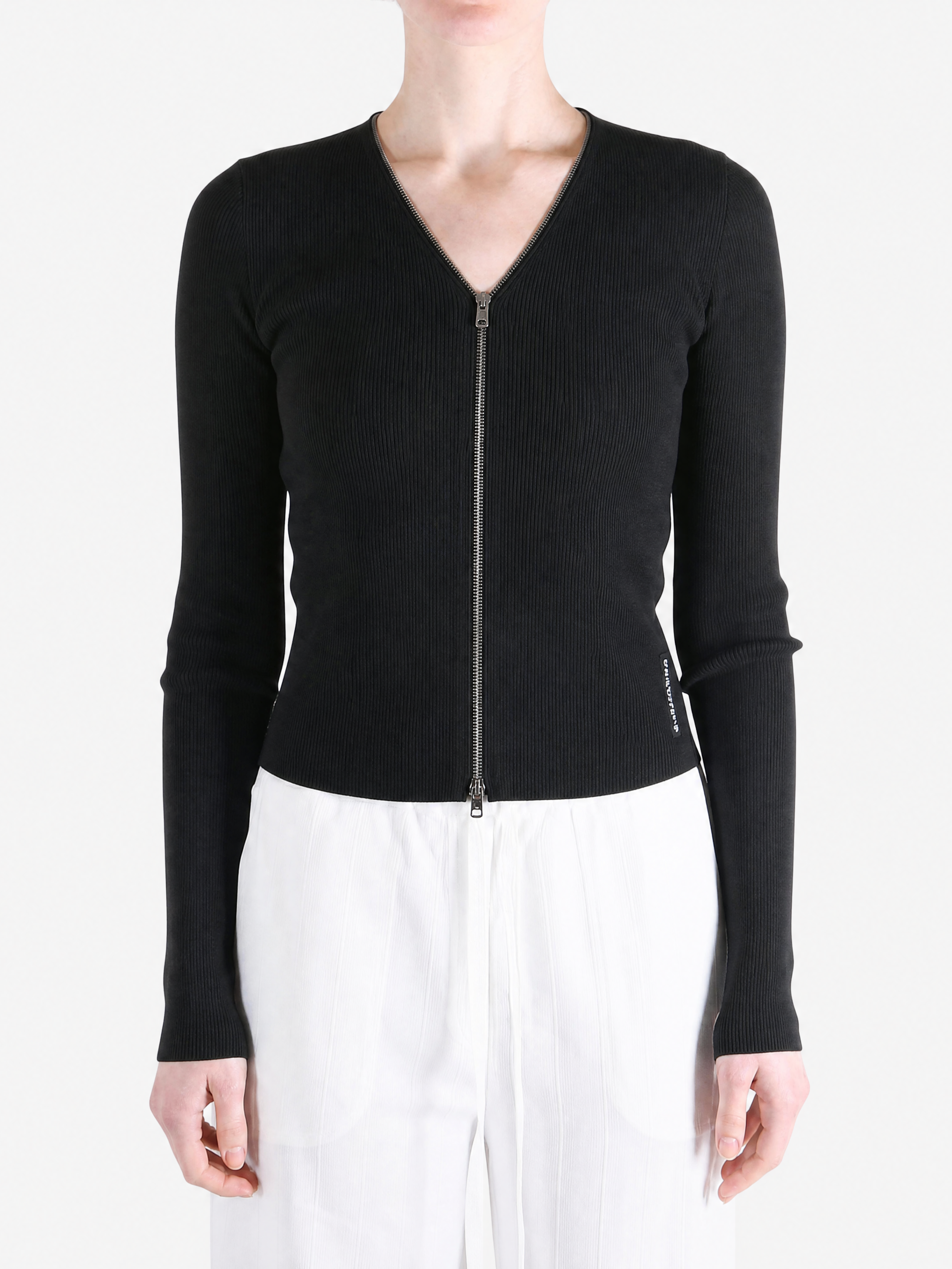 Black top worn by a person, showing the top fit