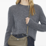 green bags worn by a person, showing the bags fit