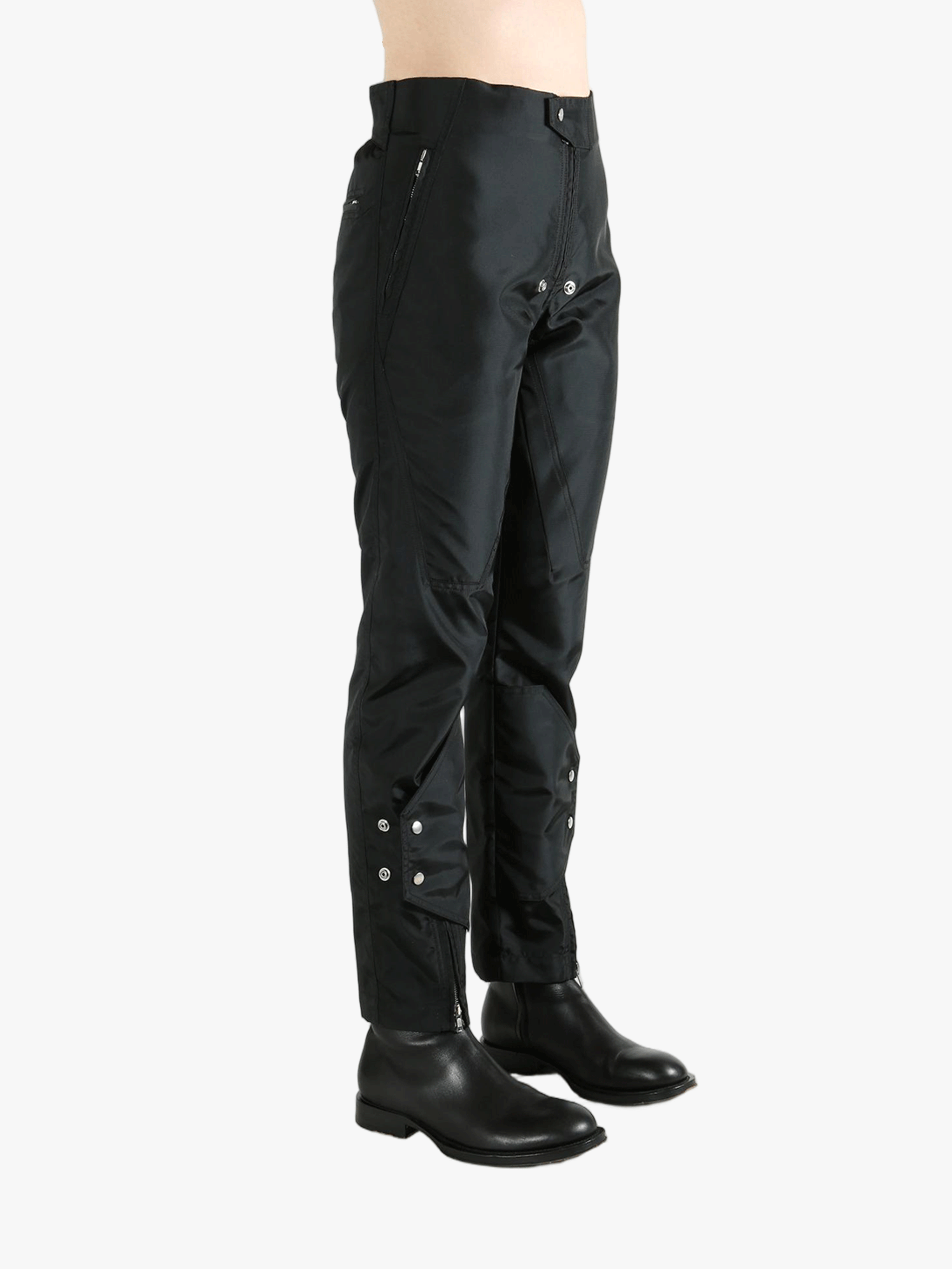 Black pants worn by a person, showing the pants' fit