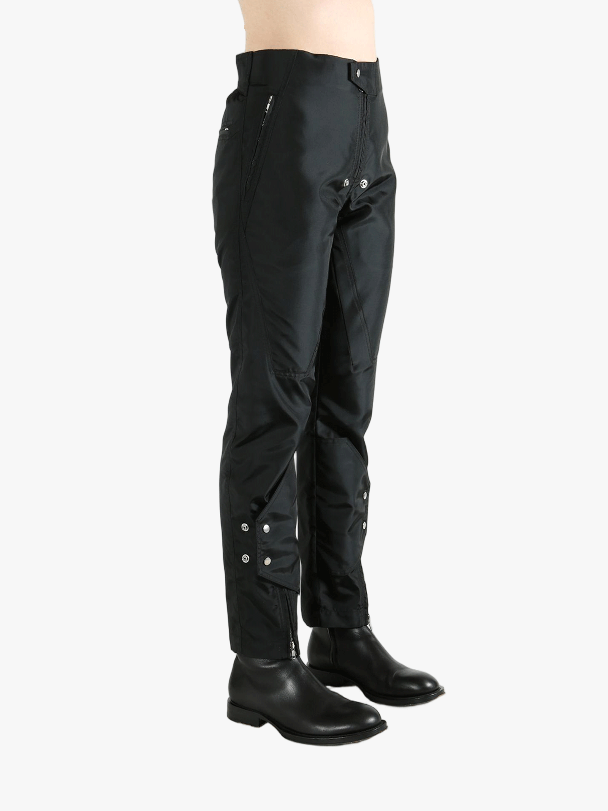 Black pants worn by a person, showing the pants' fit
