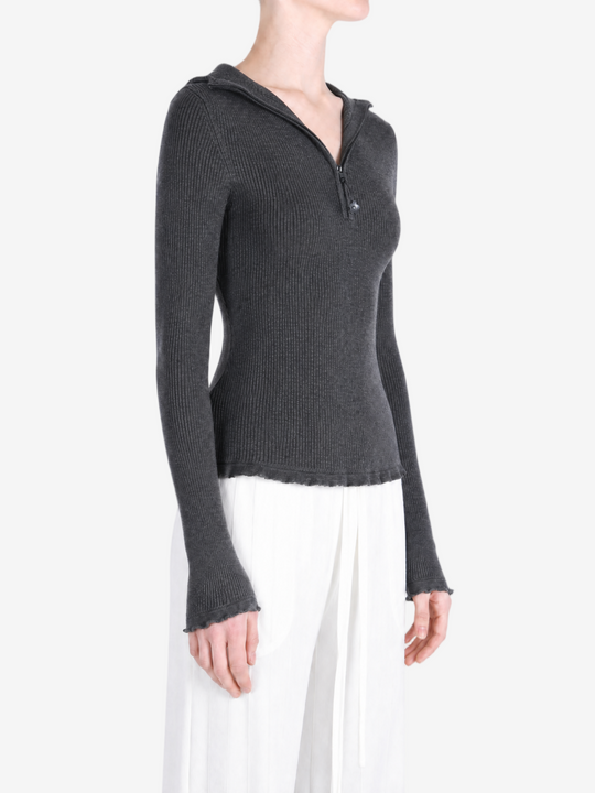 Grey hoodie worn by a person, showing the hoodie fit