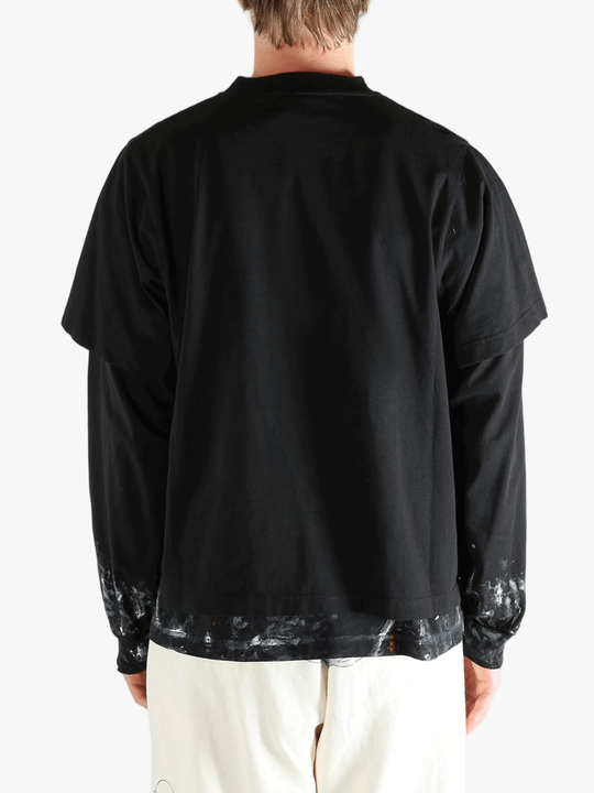 Black t-shirts worn by a person, showing the t-shirts fit