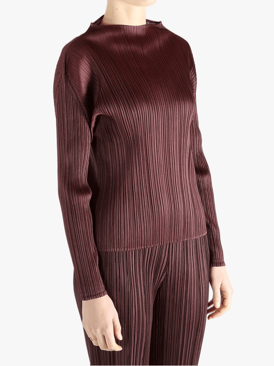 Burgundy shirt worn by a person, showing the shirt fit