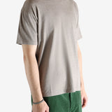 Brown t-shirt worn by a person, showing the shirt's fit