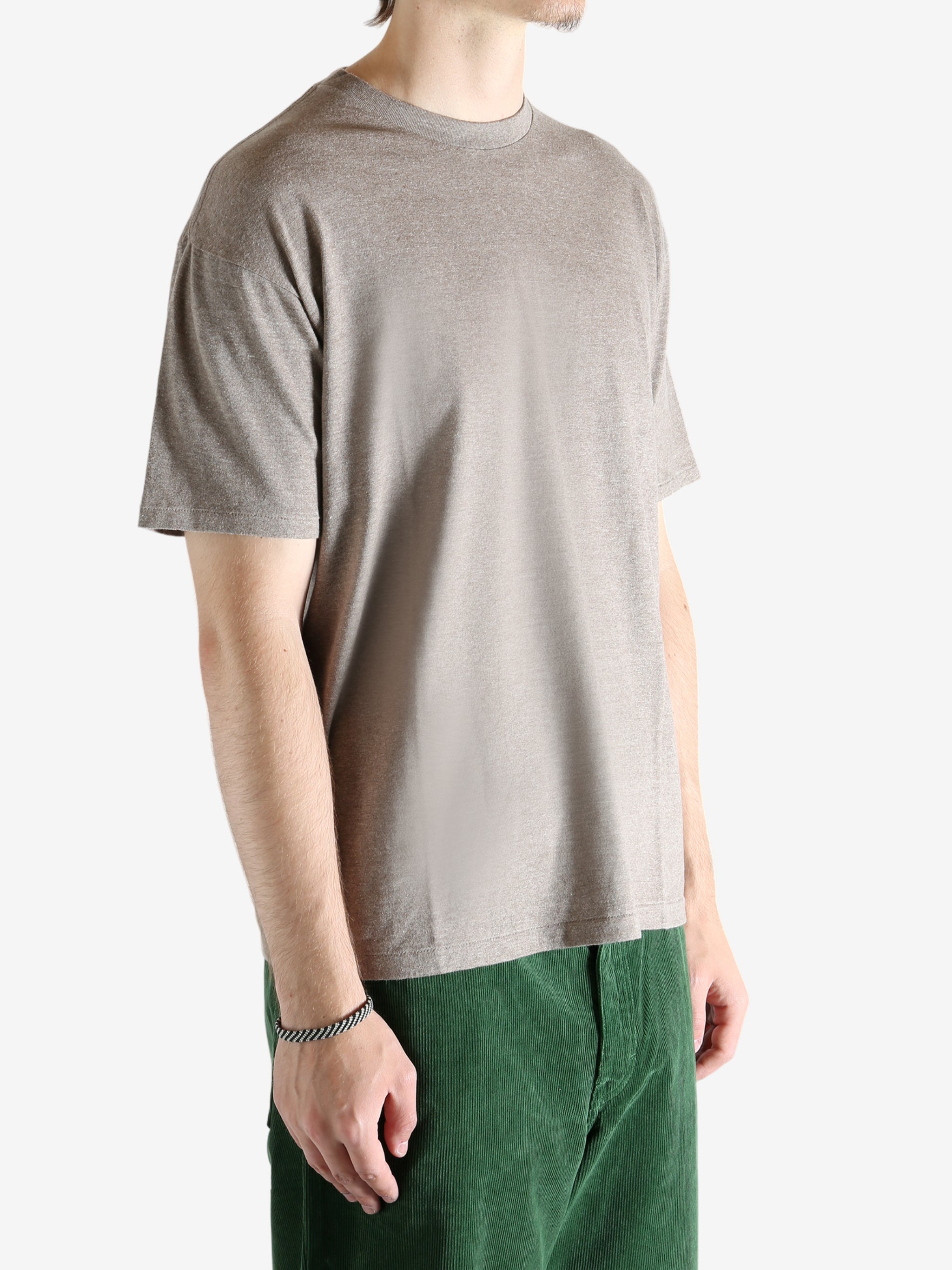 Brown t-shirt worn by a person, showing the shirt's fit