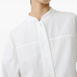 White shirt worn by a person, showing the shirt's fit