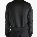 Black jackets worn by a person, showing the jackets fit