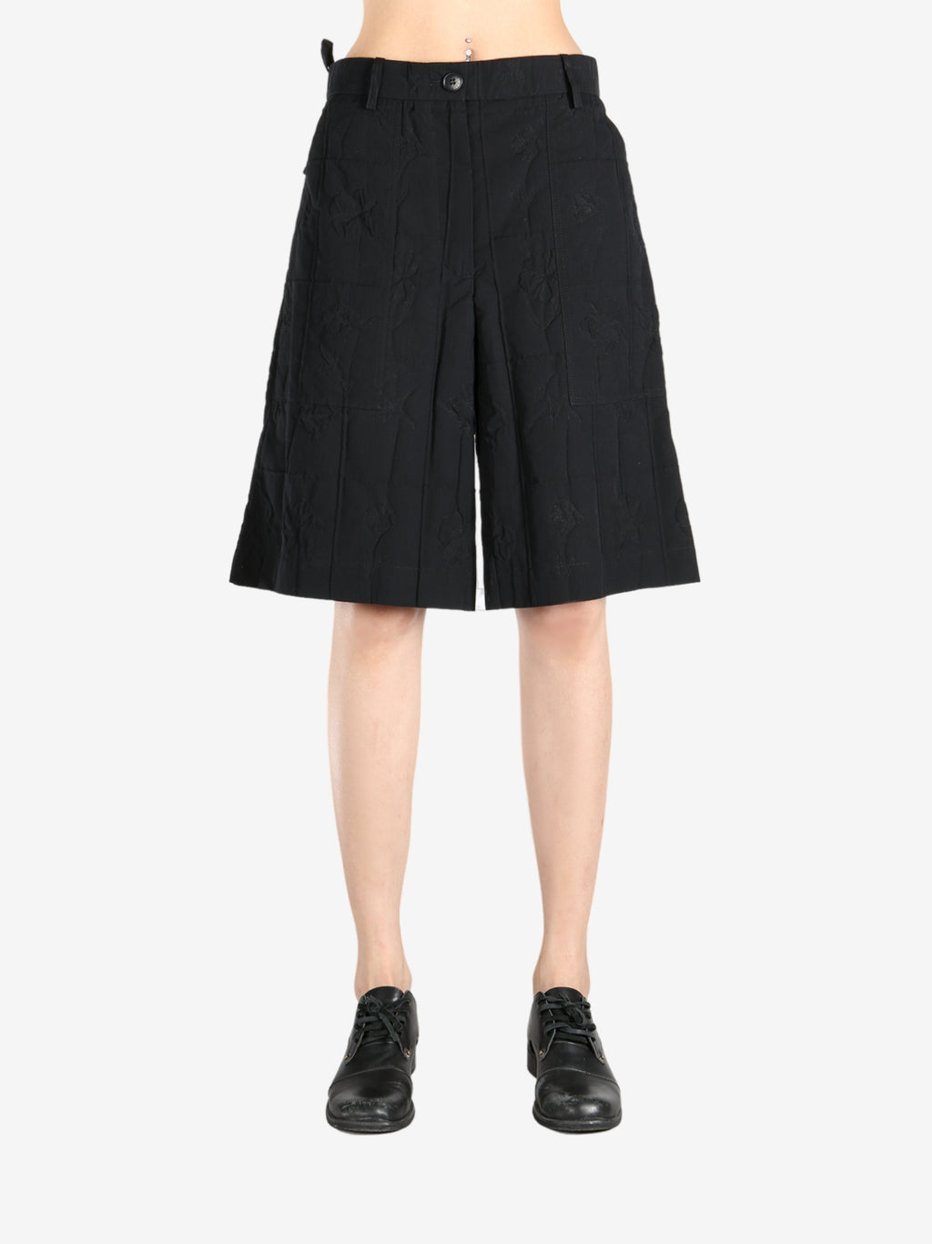 Black short worn by a person, showing the short's fit