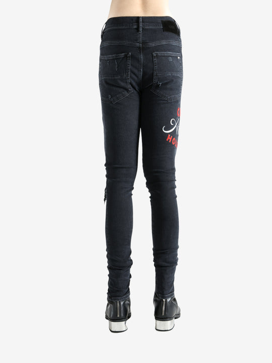 Black jeans worn by a person, showing the jeans fit