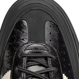 Close up of Black sneakers, showing texture of the Calf Leather fabric