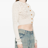 Yellow cardigan worn by a person, showing the cardigan's fit