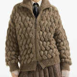 Brown knitwear worn by a person, showing the knitwear fit