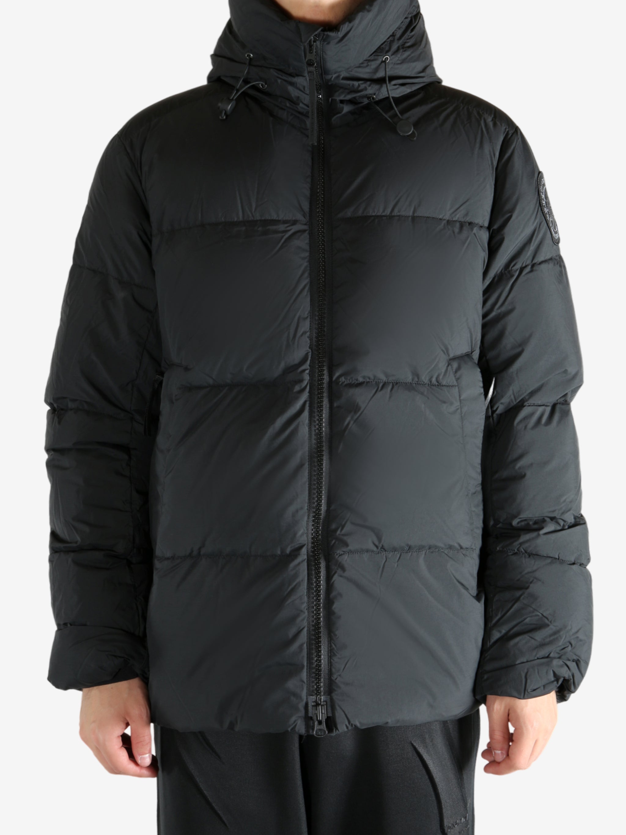 Black coat worn by a person, showing the coat's fit