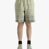 Green shorts worn by a person, showing the shorts fit