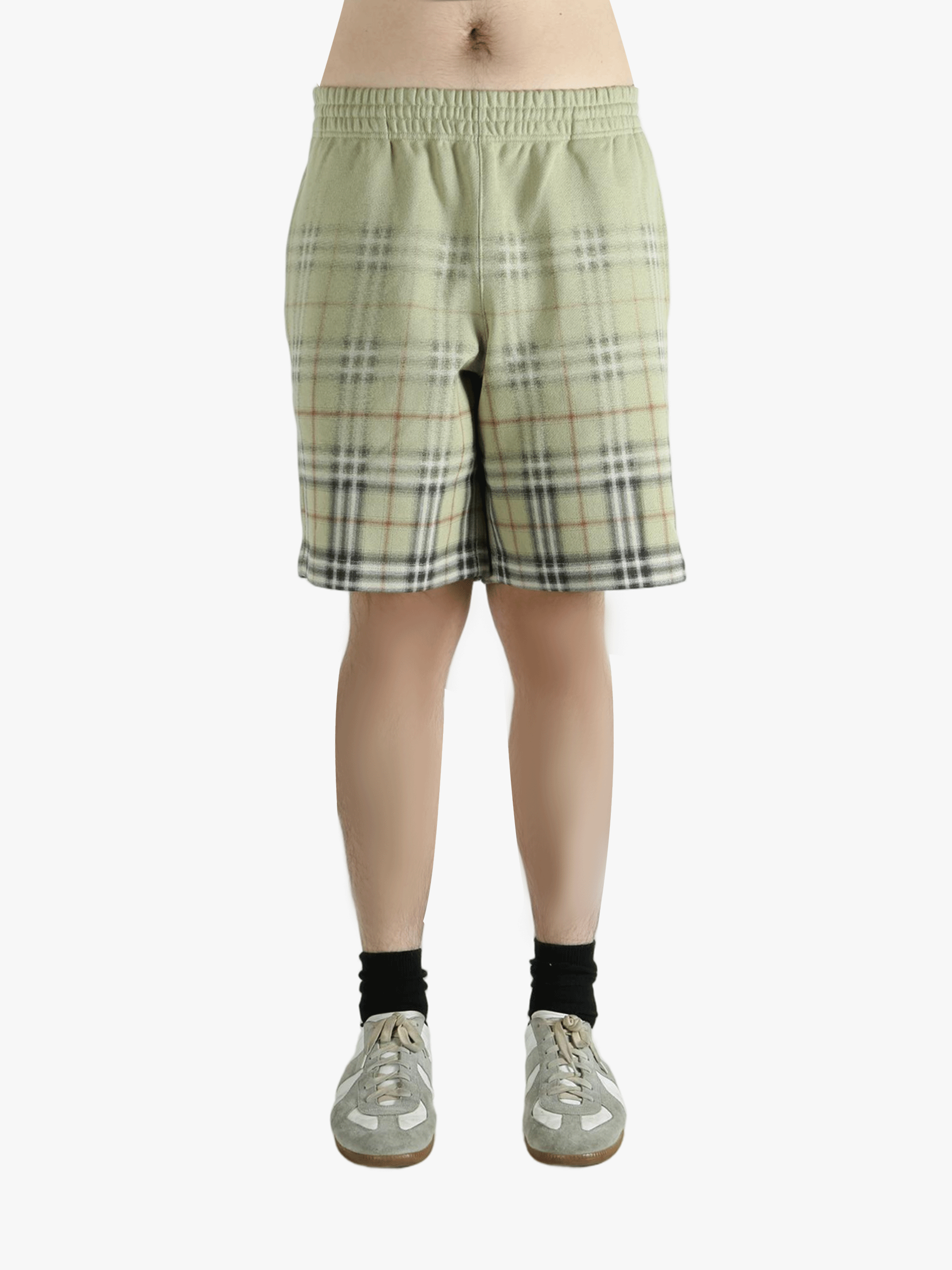Green shorts worn by a person, showing the shorts fit