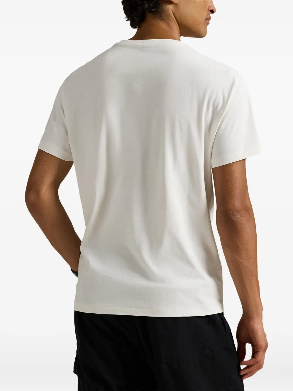White shirt worn by a person, showing the shirt's fit