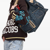 blue bags worn by a person, showing the bags fit