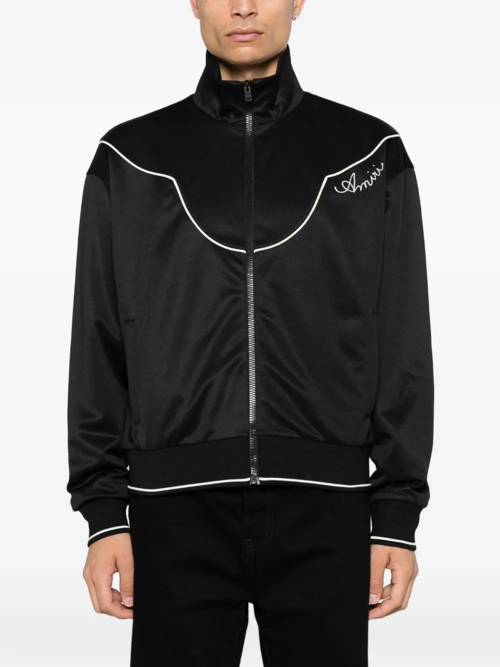 Black jacket worn by a person, showing the jacket fit