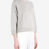 Grey knitwear worn by a person, showing the knitwear fit
