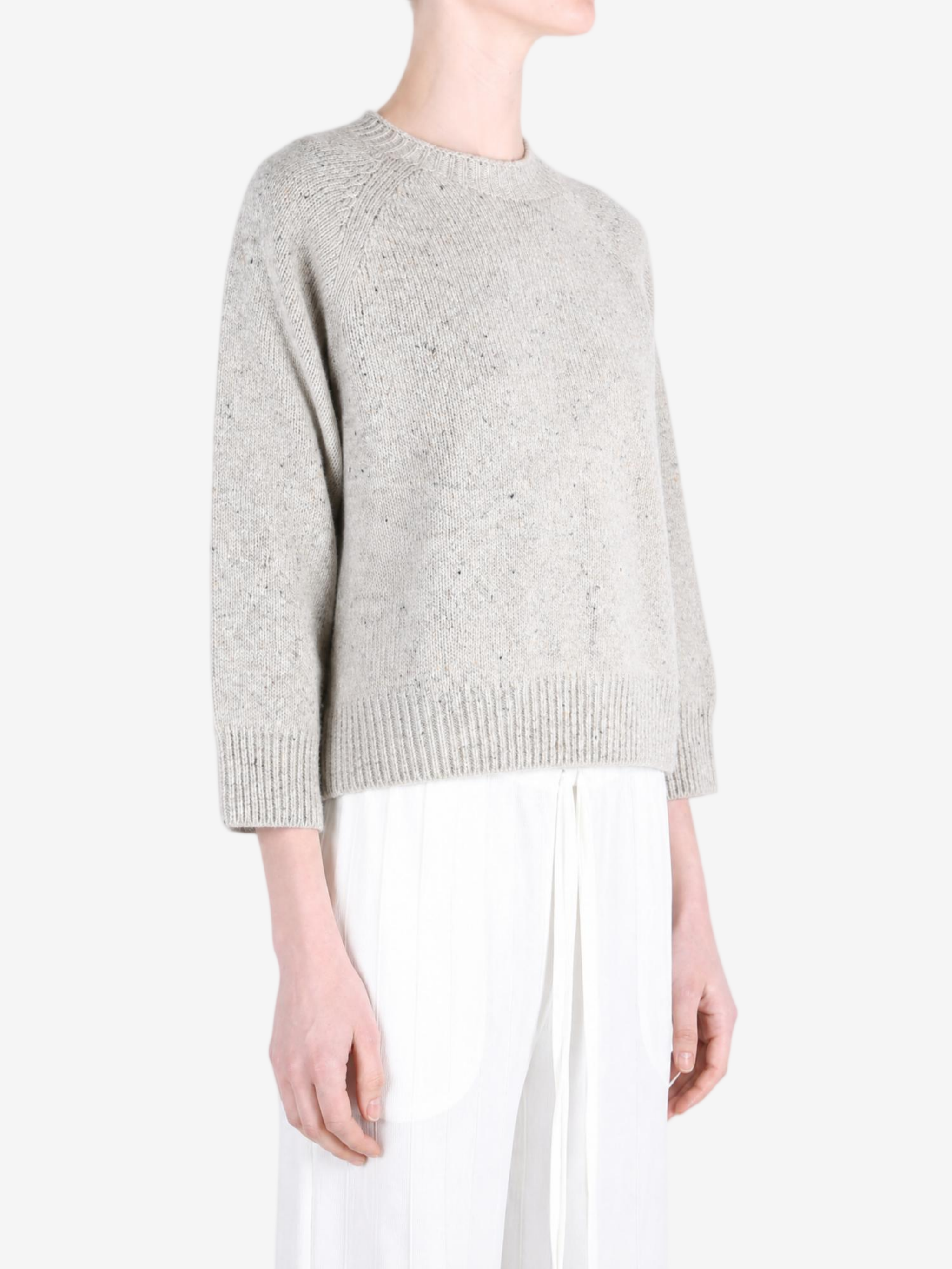 Grey knitwear worn by a person, showing the knitwear fit
