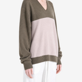 Brown hoodie worn by a person, showing the hoodie fit