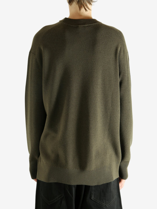 Crew knitwear worn by a person, showing the knitwear's fit