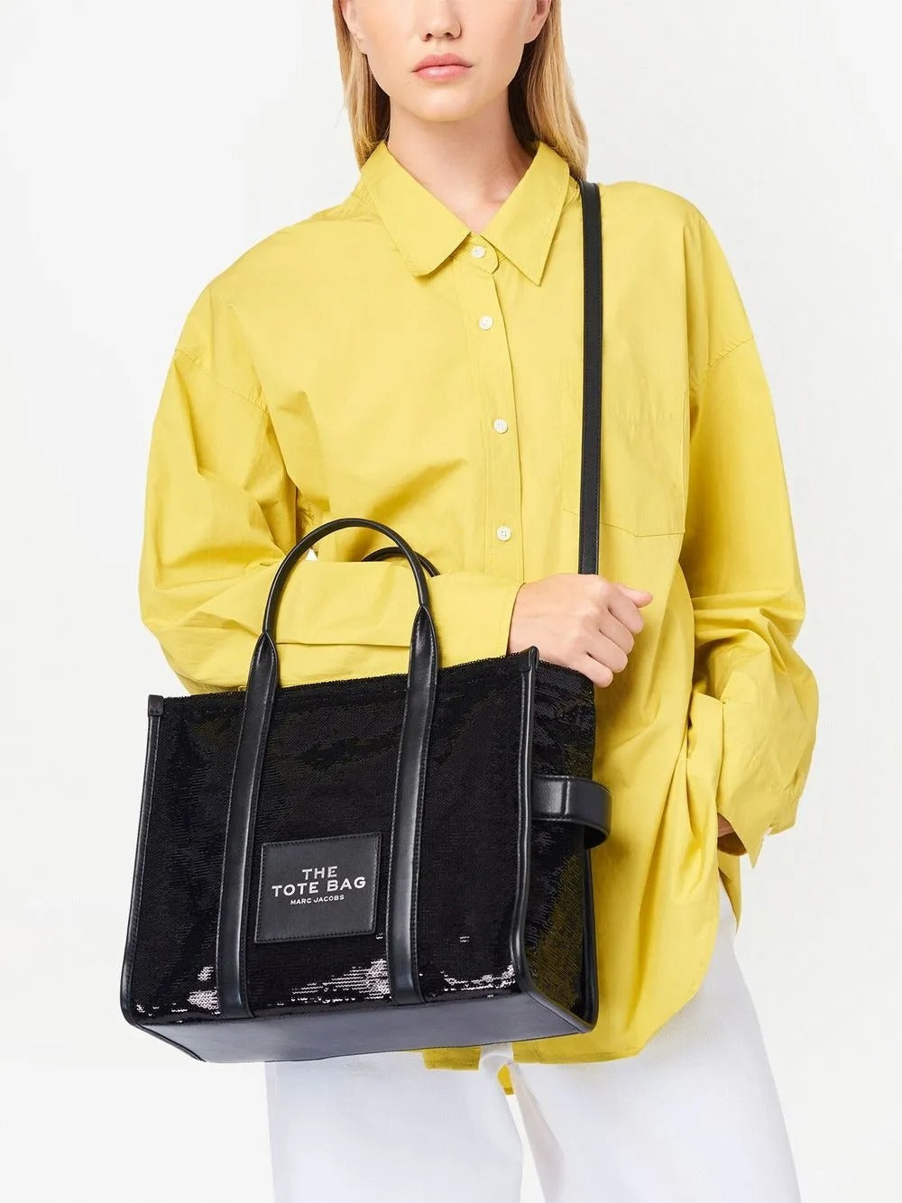 Black bag carried by a person, showing the bag's fit