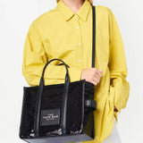 Black bag carried by a person, showing the bag's fit