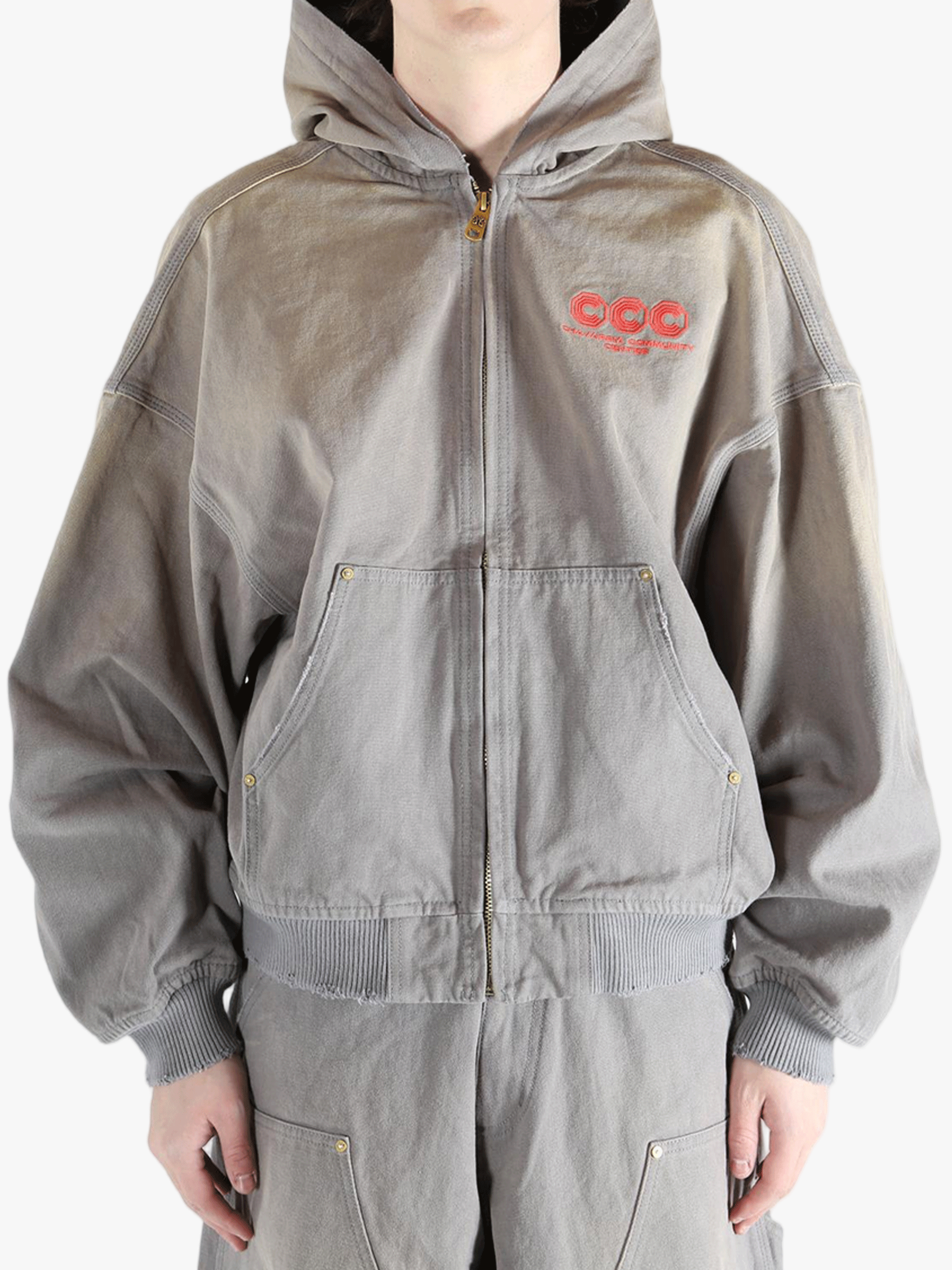 Grey hoodie, worn by a person, showing the hoodies fit