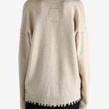 Tan knitwear worn by a person, showing the knitwear fit