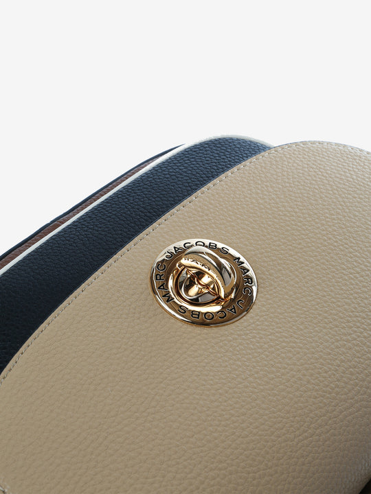 Close up of tan bag, showing texture of the cow leather fabric