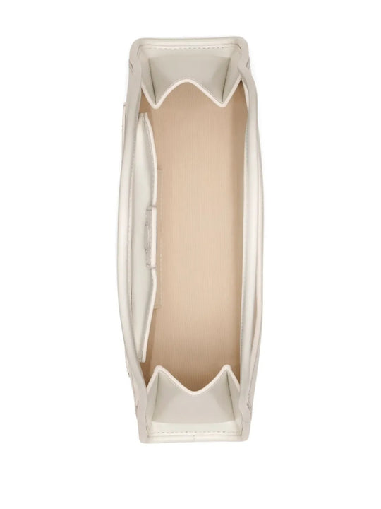 Close up of the white bag, showing texture of the leather fabric