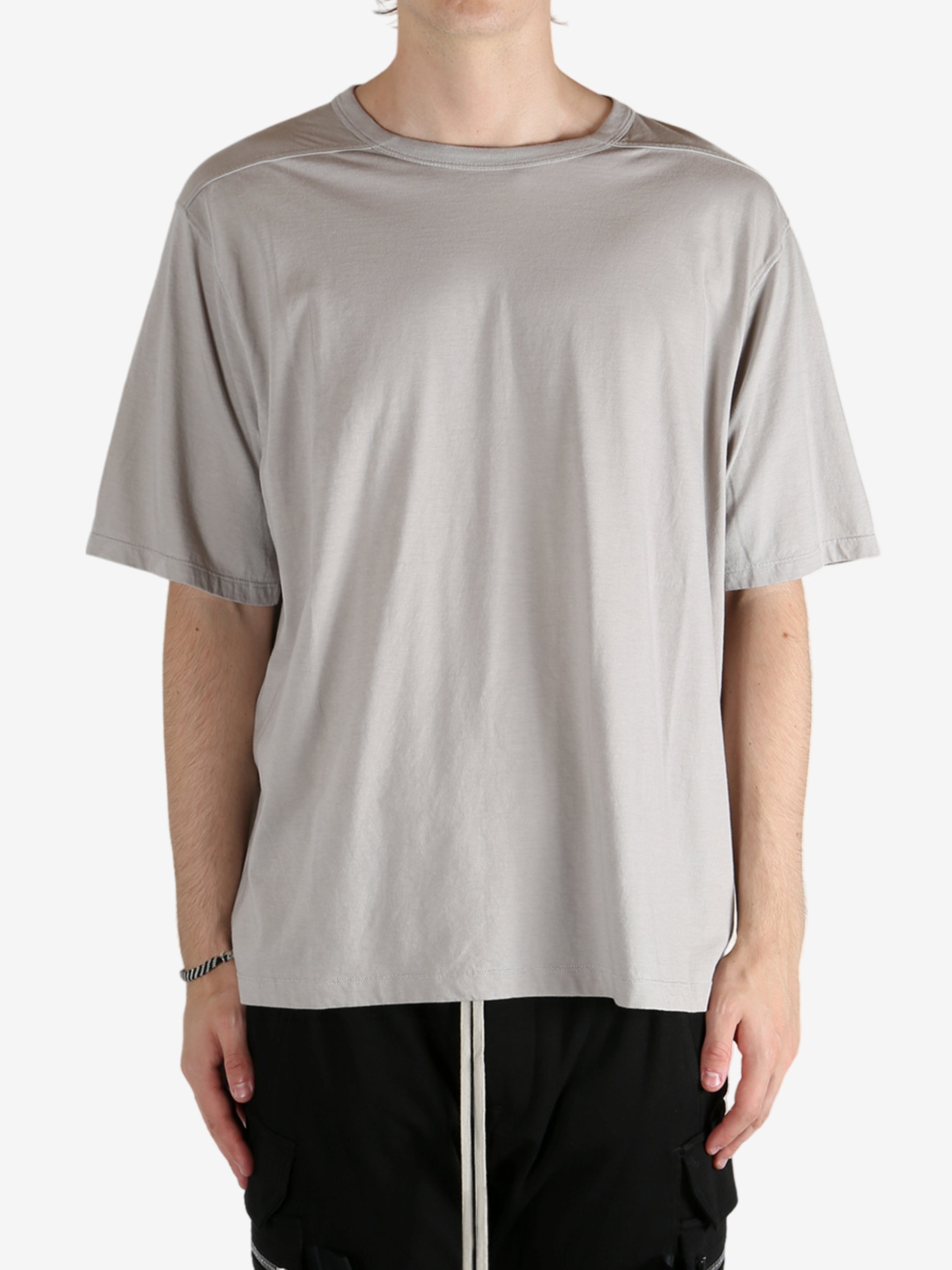 Grey shirts worn by a person, showing the shirt's fit