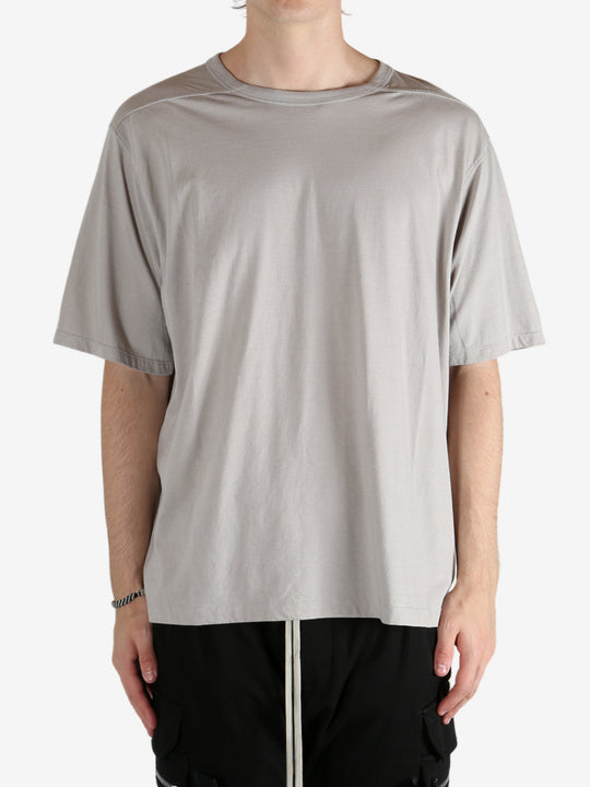 Grey shirts worn by a person, showing the shirt's fit