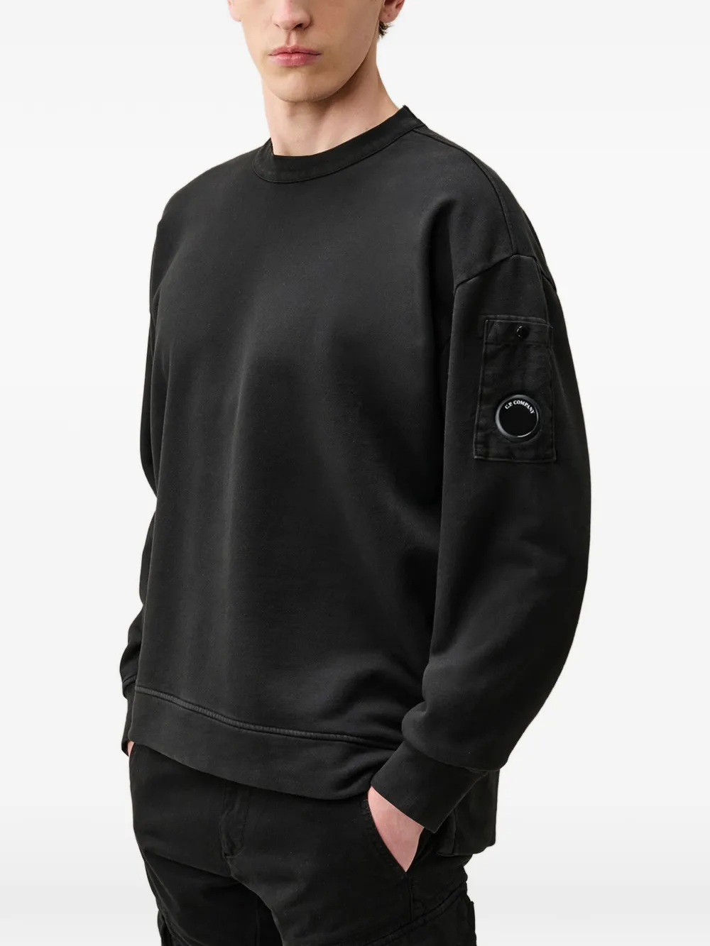 Black hoodie worn by a person, showing the hoodie fit