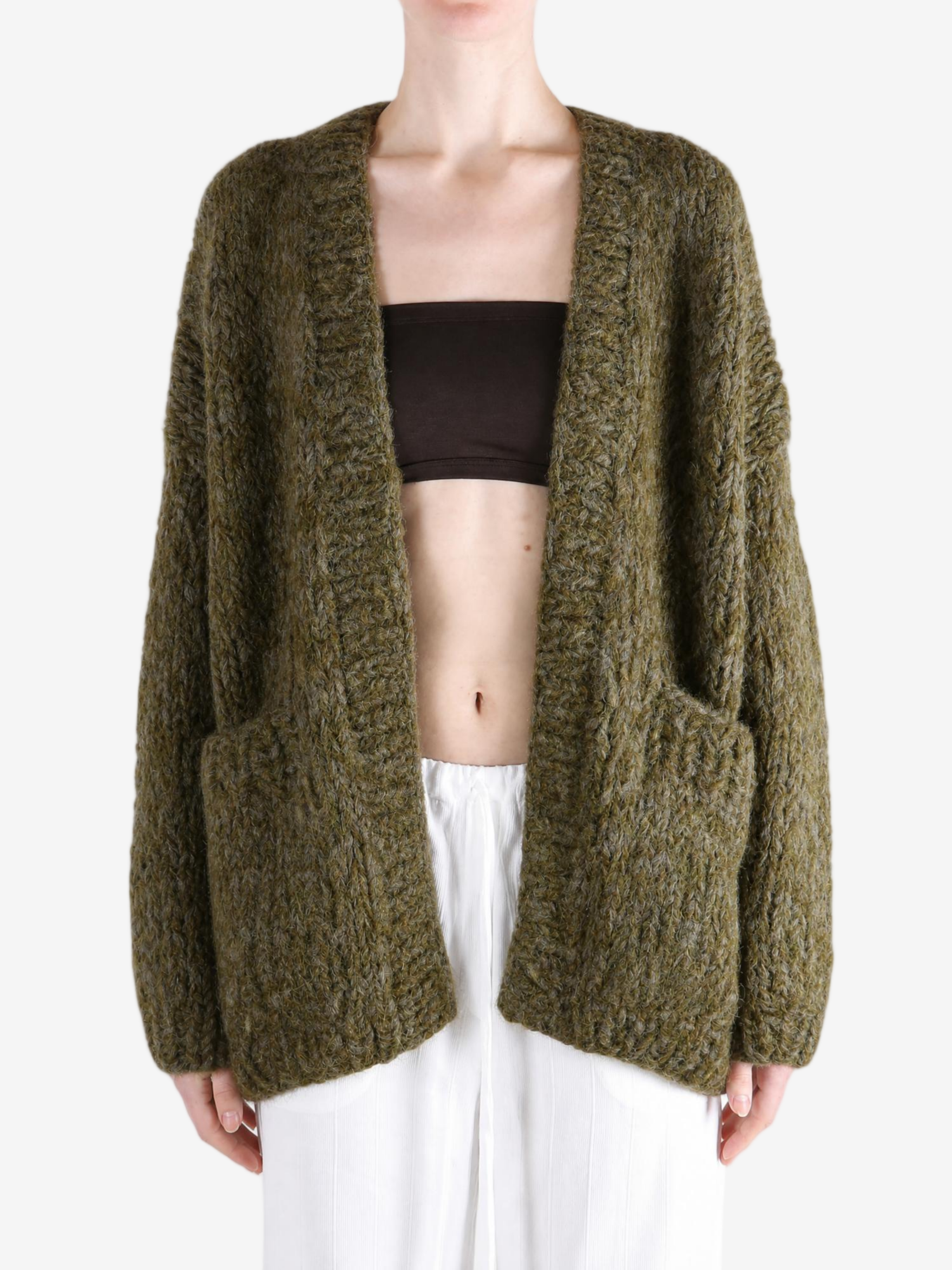 Green knitwear worn by a person, showing the knitwear fit