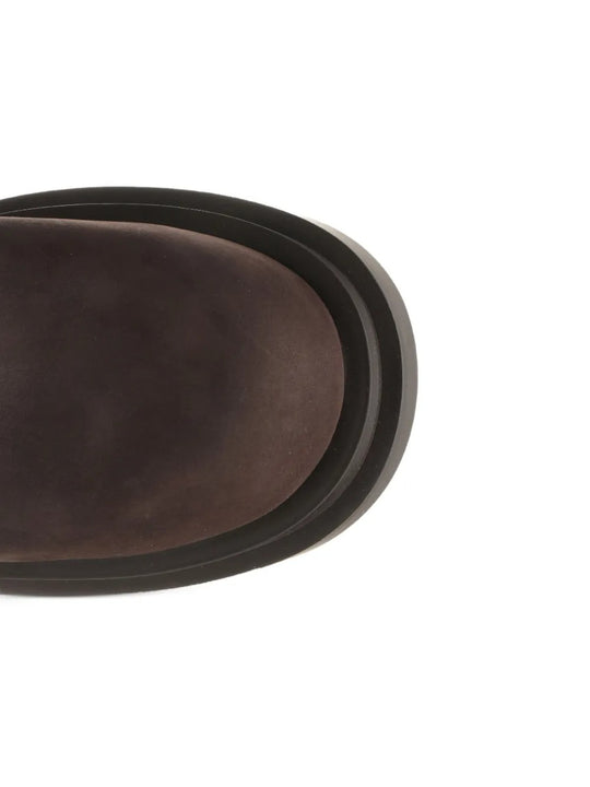 Close up of the brown boots, showing texture of the leather fabric