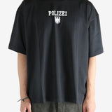 Black shirt worn by a person, showing the shirt's fit