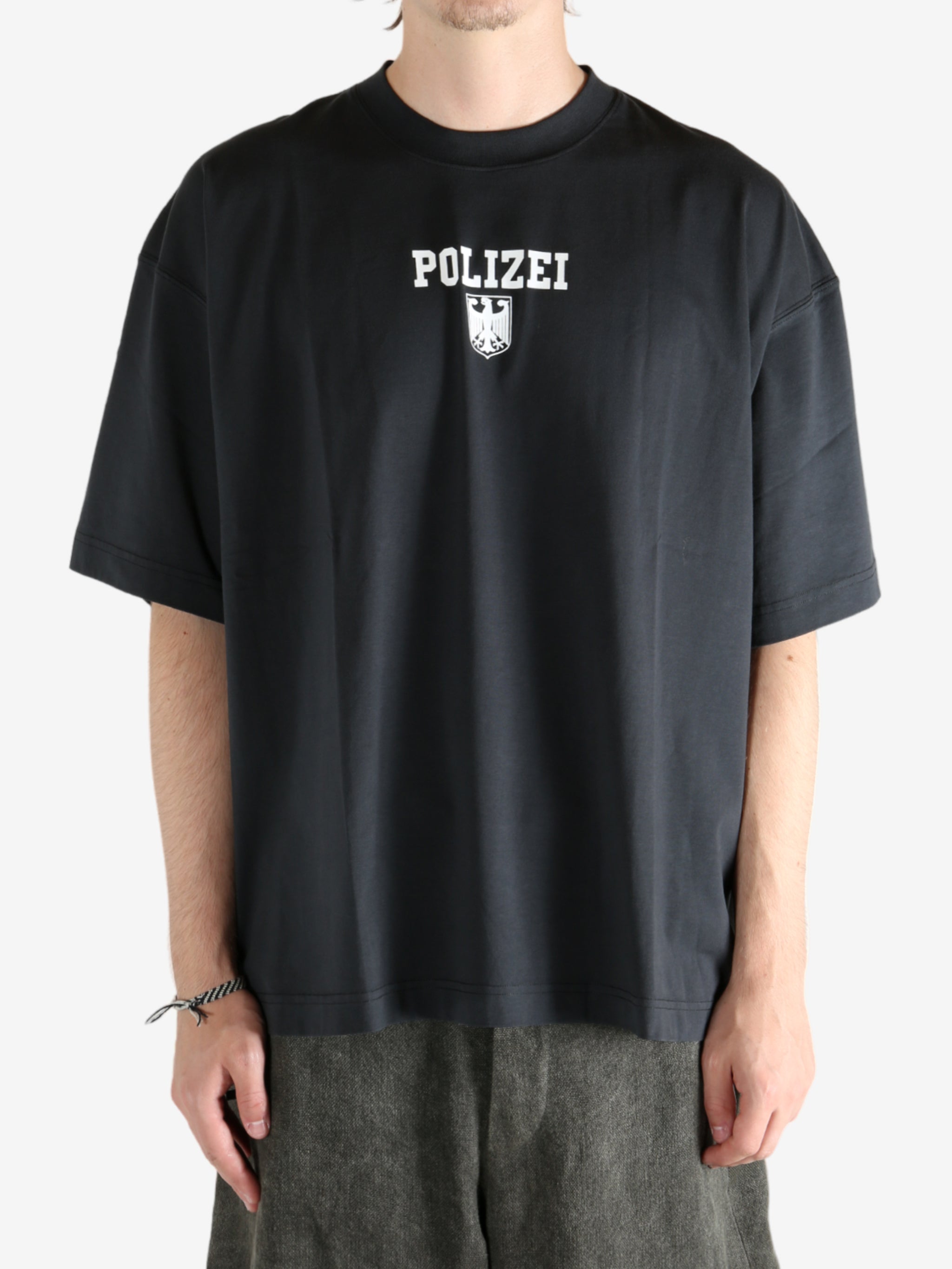 Black shirt worn by a person, showing the shirt's fit