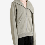 Grey hoodie worn by a person, showing the hoodie fit
