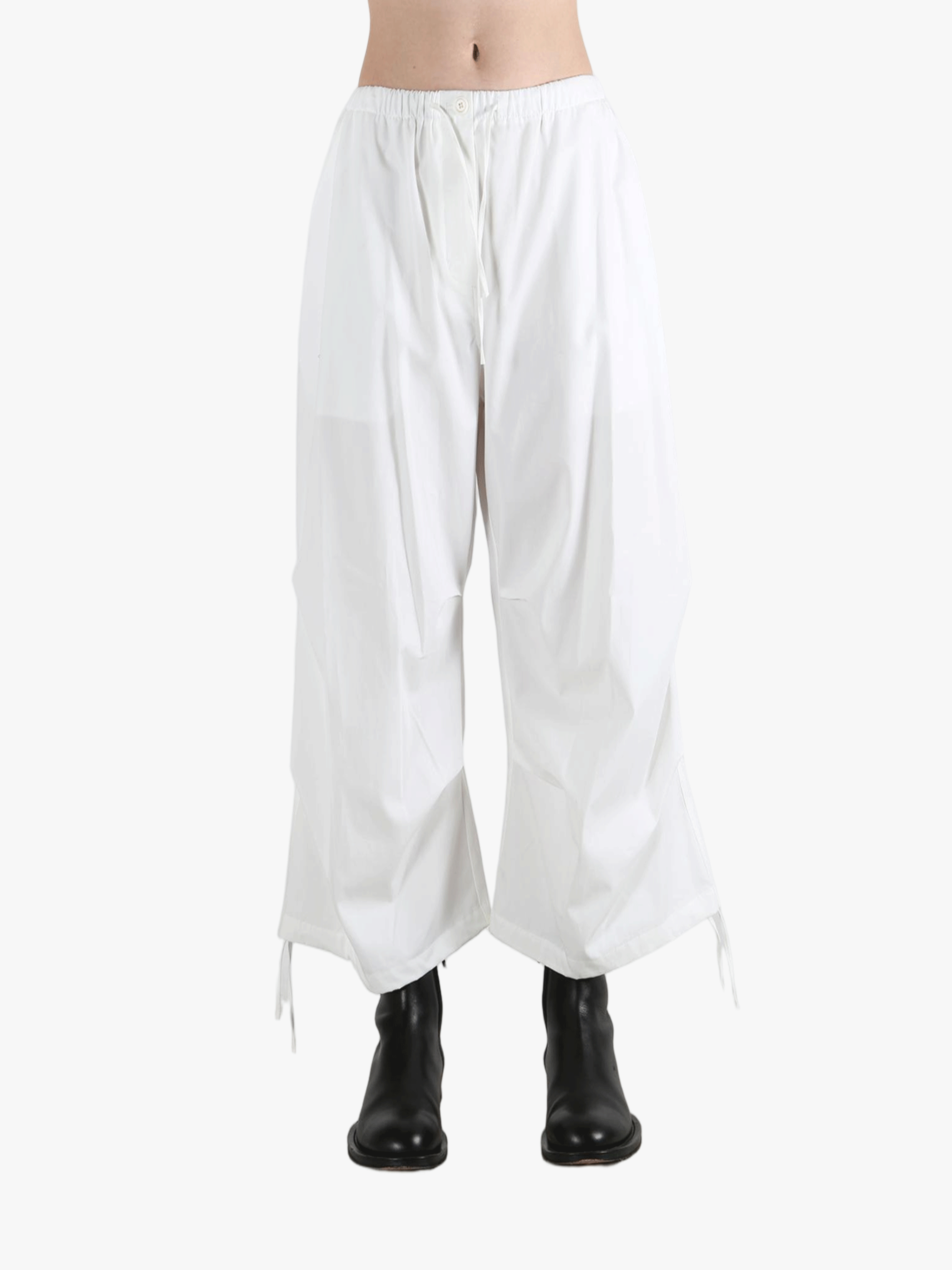 White pants worn by a person, showing the pants' fit