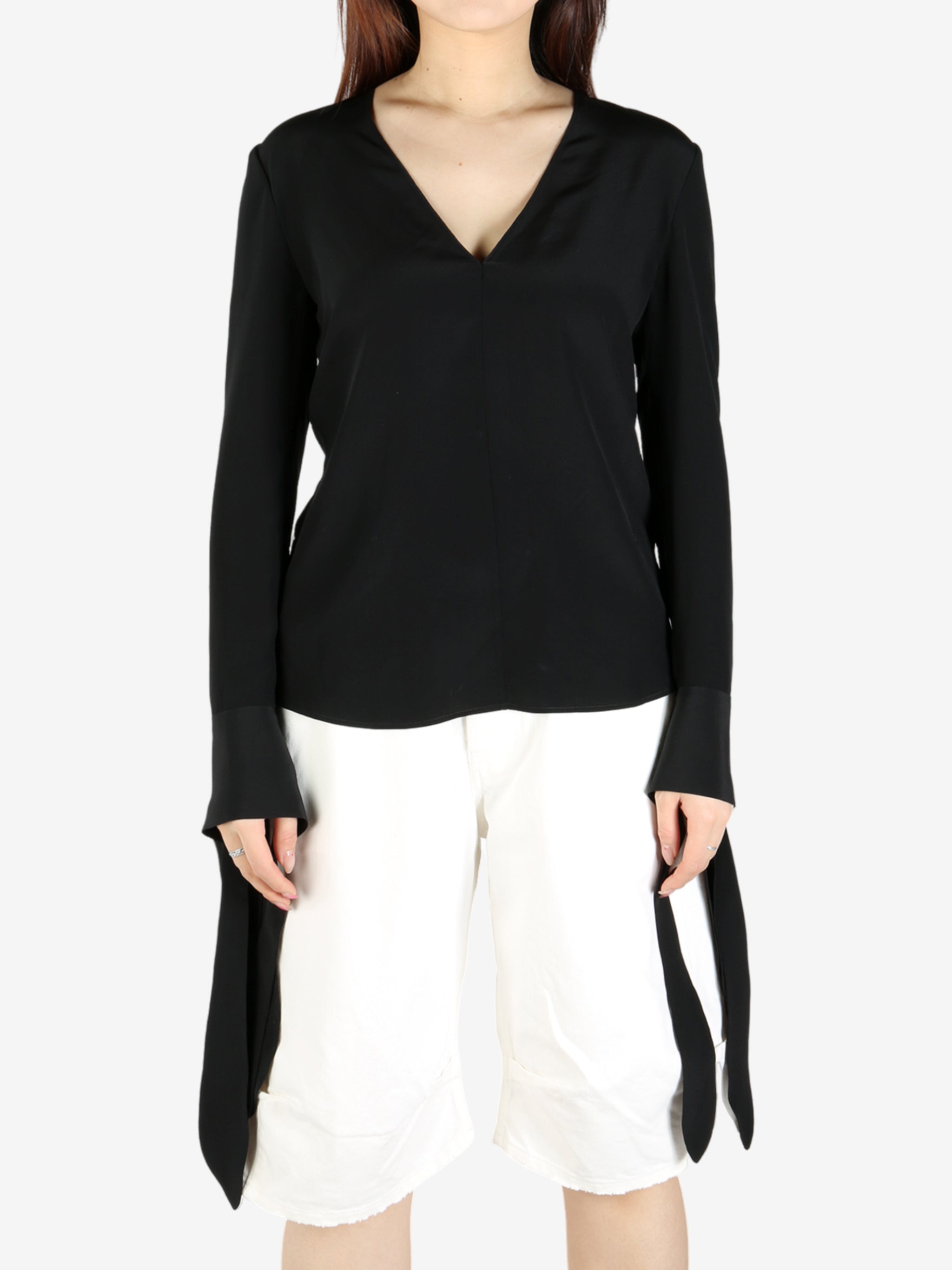 Black top worn by a person, showing the top's fit