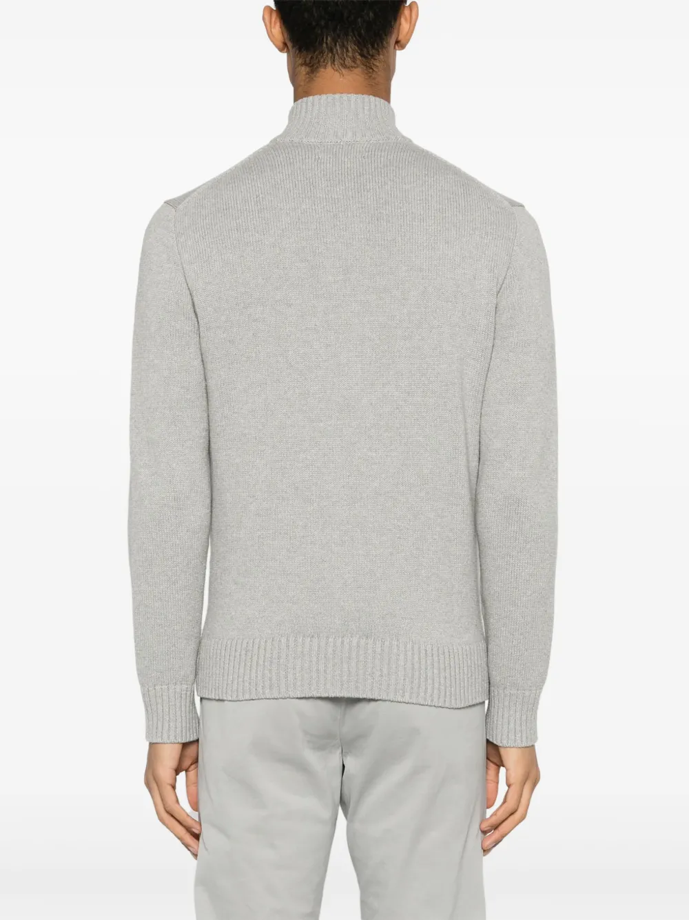 Grey knitwear worn by a person, showing the knitwear fit